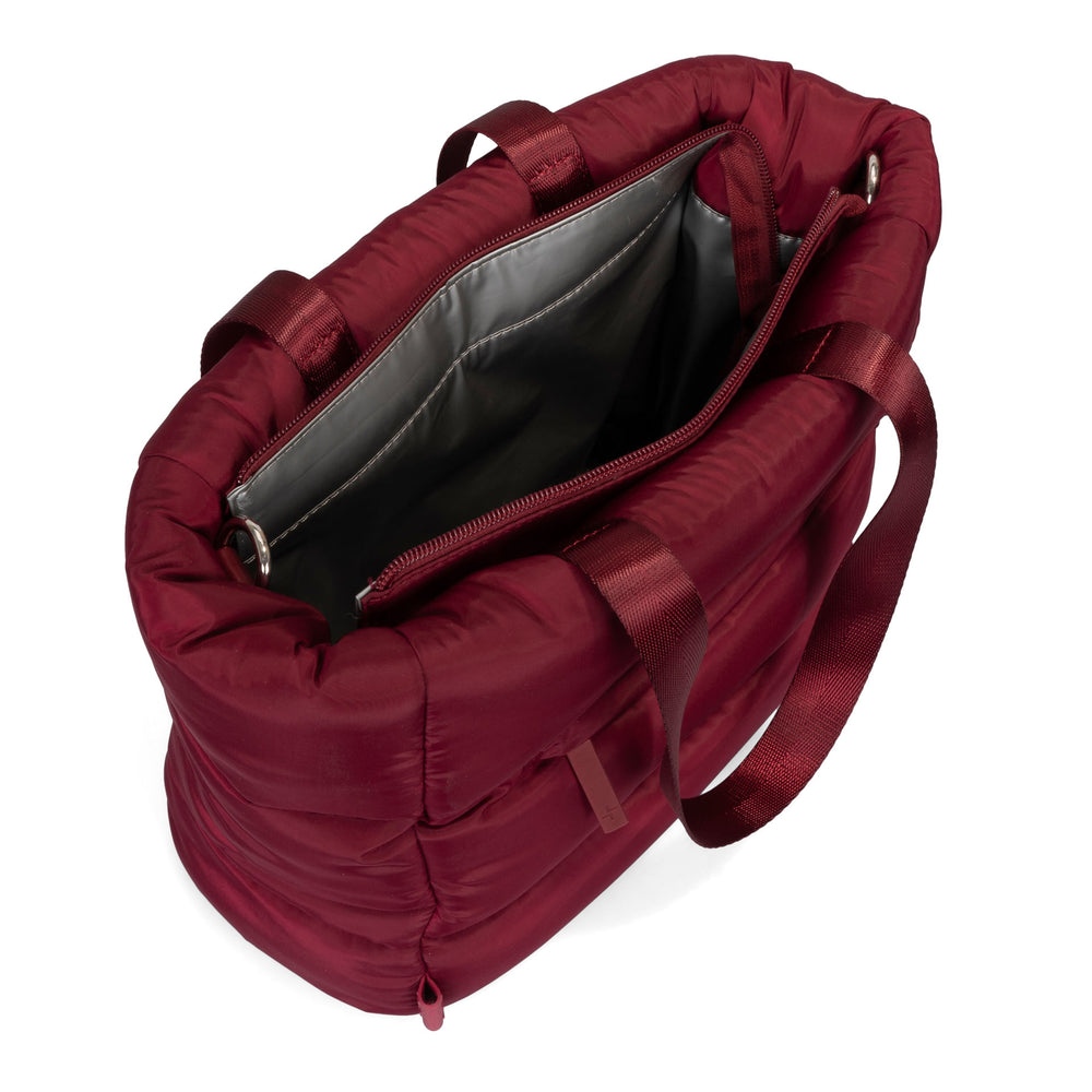 Angle view of a red lunch tote bag called Urban Quilted designed by Tracker on a white background, showcasing its interior.