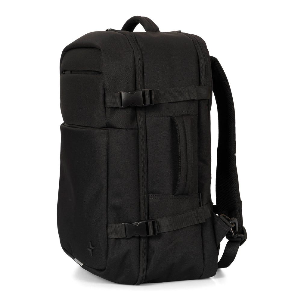 Side view of a black backpack called West Bay 3.0 Convertible designed by Tracker showing its side clips, side handle, top handle, one shoulder strap, and two front pockets.