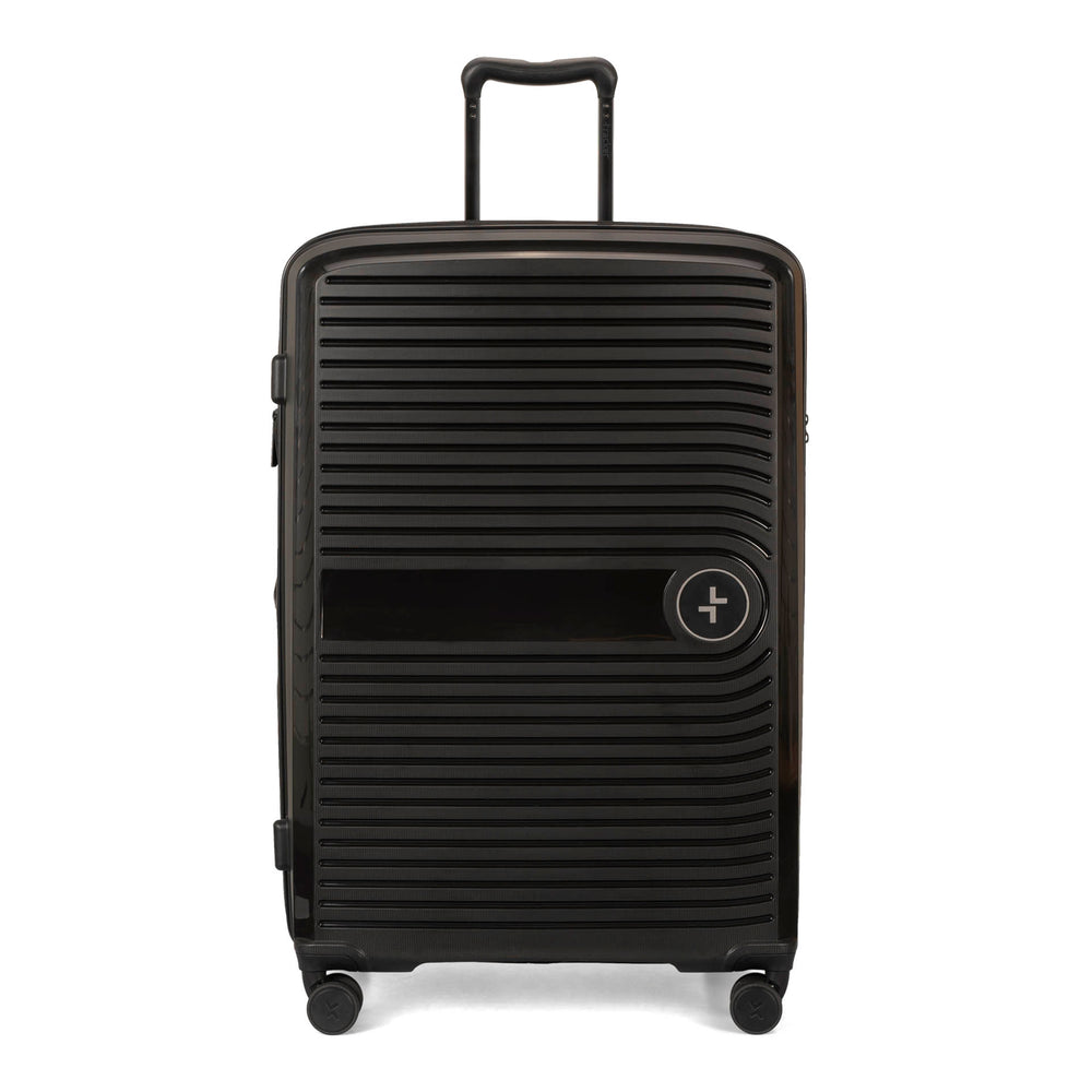 Front side of a black luggage called Dynamo designed by Tracker showing its telescopic handle, lined-pattern shell, and tracker symbol embossed on the front.