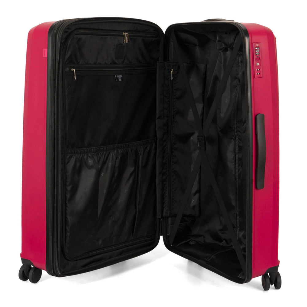 Interior view of a red luggage called Dynamo designed by Tracker showing its interior brand lining, compression straps, and multiple pockets.