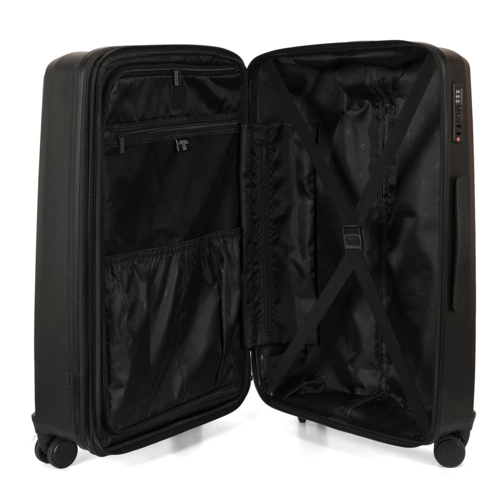 Interior view of a black luggage called Dynamo designed by Tracker showing its interior brand lining, compression straps, and multiple pockets.