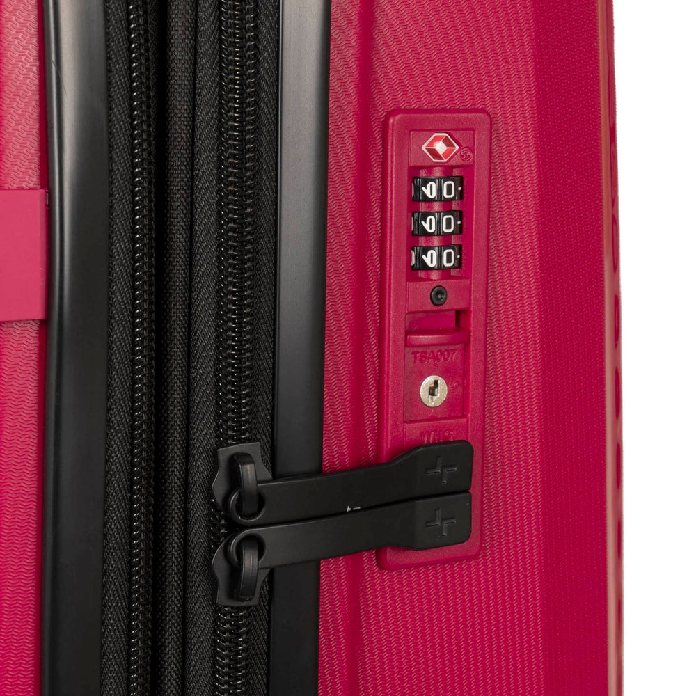 Close up of a red luggage called Dynamo designed by Tracker showing its integrated TSA lock and rugged hard shell texture.