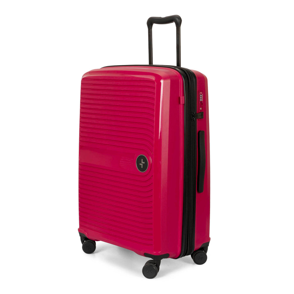 Angle view of a 25" red luggage called Dynamo designed by Tracker showing its telescopic handle, lined-pattern shell, spinner wheels, and tracker symbol embossed on the front.