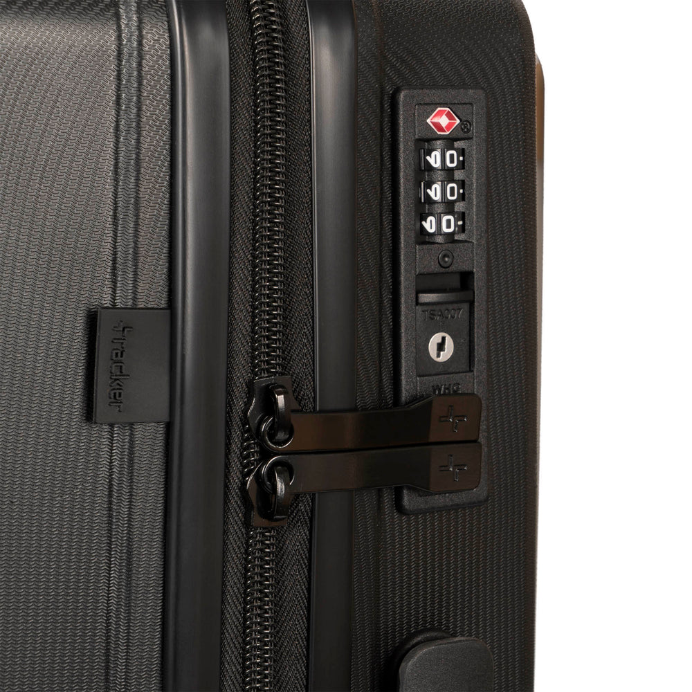 Close up of a black luggage called Dynamo designed by Tracker showing its integrated TSA lock and rugged hard shell texture.