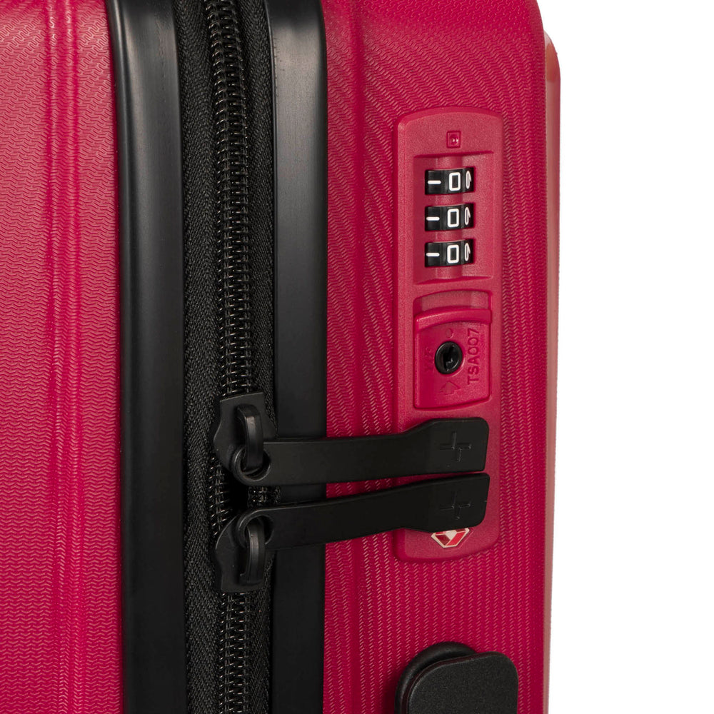 Close up of a red luggage called Dynamo designed by Tracker showing its integrated TSA lock and rugged hard shell texture.