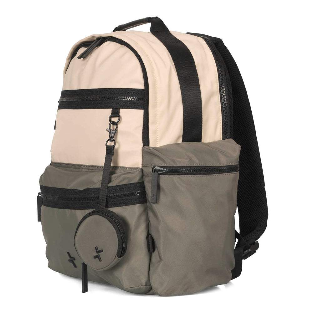 Angle view of a grey-green and beige backpack called Sutton by Tracker, showcasing its 2 front zipper pockets, an ear pod pouch, top handle and 1 adjustable and padded strap.