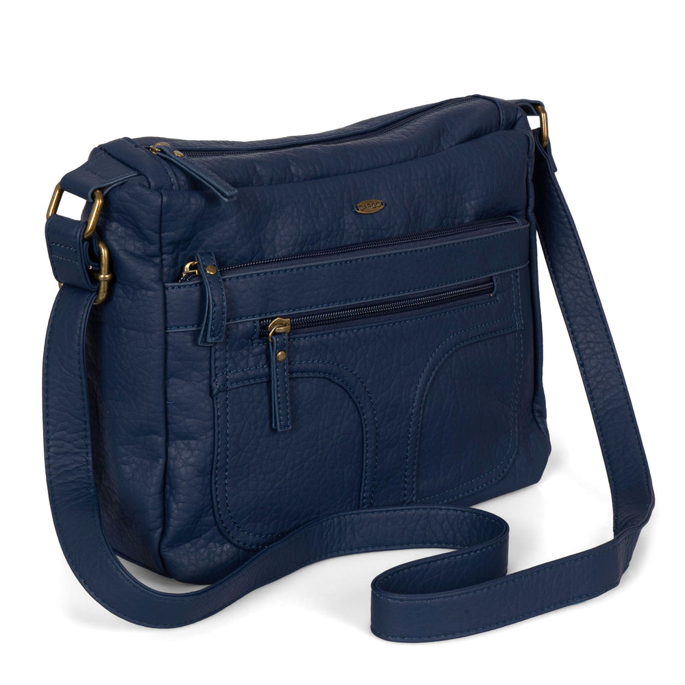 Angle view of a women's navy crossbody bag called Pebbled from the brand Cargo on a white background, showcasing its zippers, soft texture, and strap.
