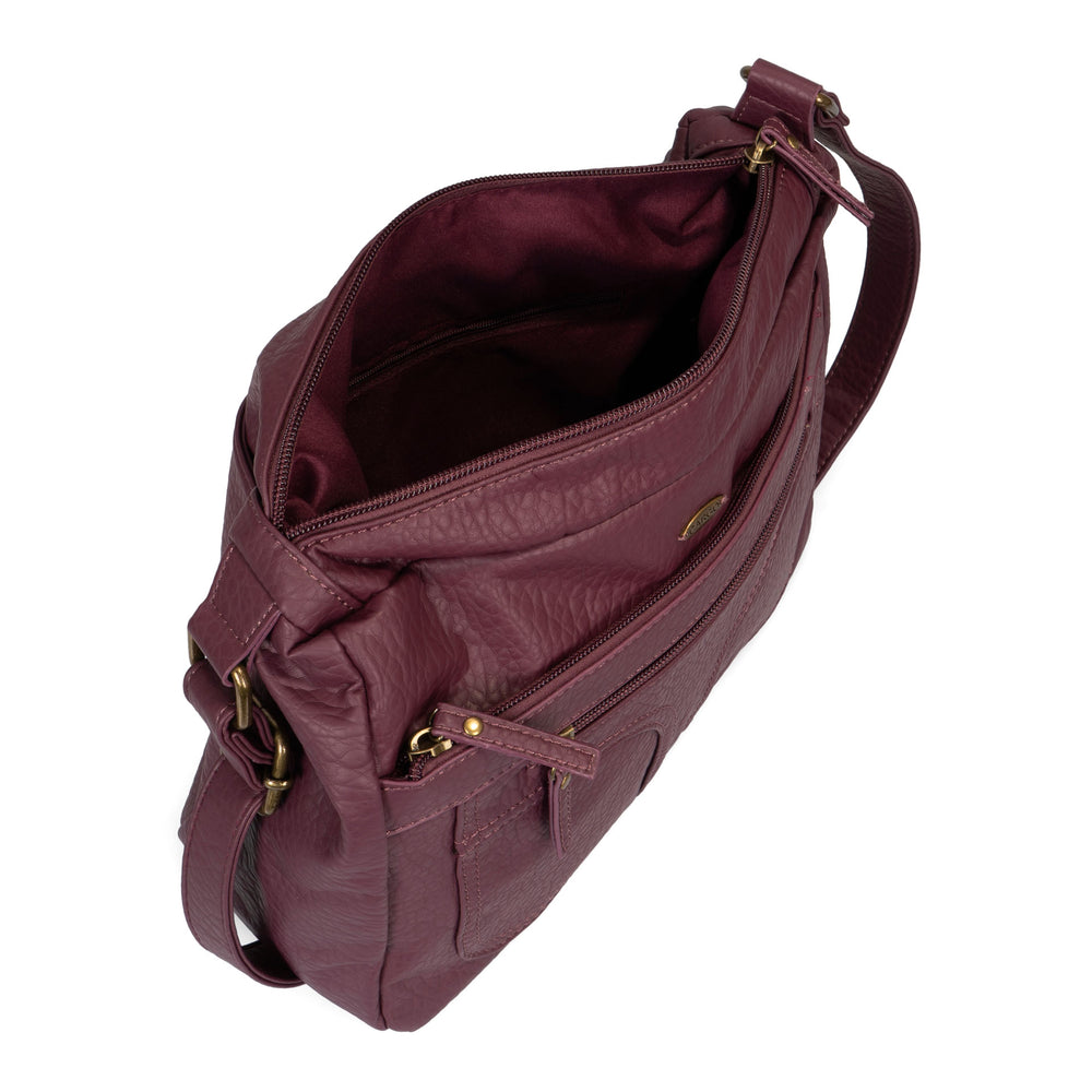 Angle view of a women's burgundy crossbody bag called Pebbled from the brand Cargo on a white background, showcasing its zippers, soft texture, and opened interior.