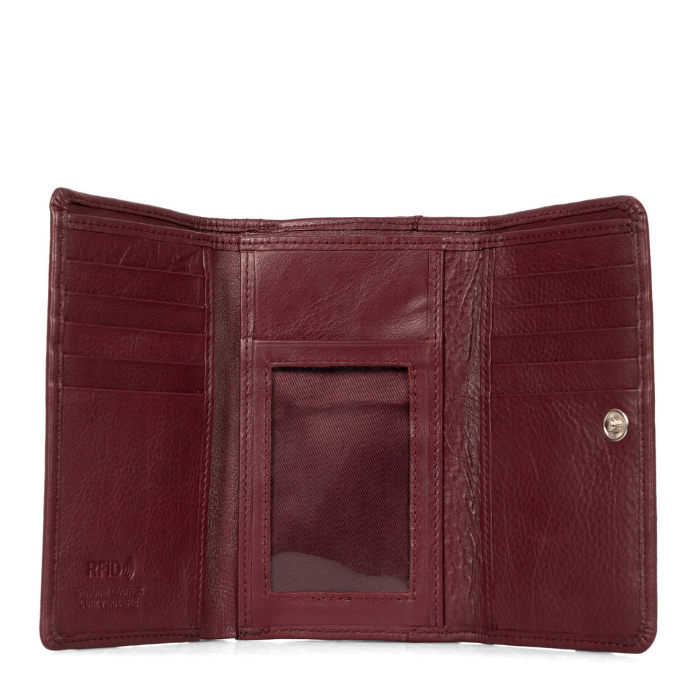 Interior view of a burgundy flap wallet for women called Kara designed by Tracker showing the RFID logo embossed, multiple credit card slots, soft leather, and ID window.