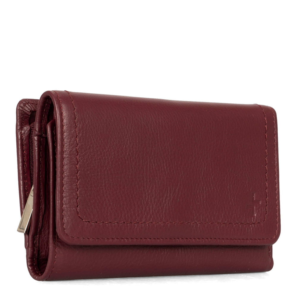 Angle view of a burgundy flap wallet for women called Kara designed by Tracker showing its logo and soft leather.