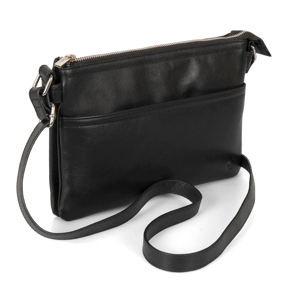 Angle view of a black crossbody bag called Basics designed by Tracker showing its supple leather texture and crossbody strap.