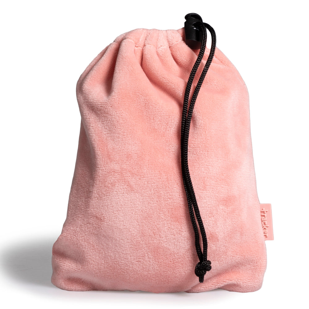 Pink fleece textured pouch with the drawstring dangling on its side show its tracker logo at the bottom right. 