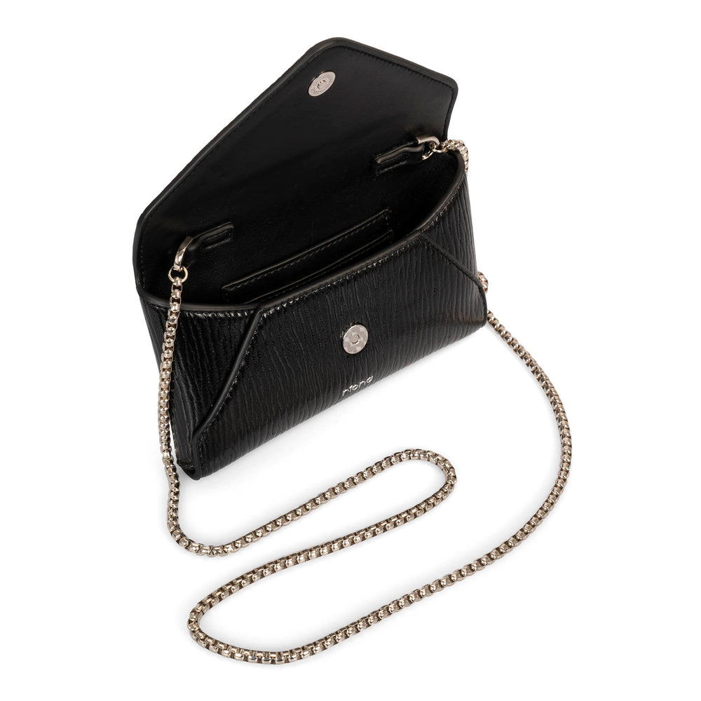 Over head view of a black glossy vegan crossbody bag called Evening in an envelopy style designed by Riona, showcasing its chain strap, matching black colour interior, an rfid pocket, and snap button closure.