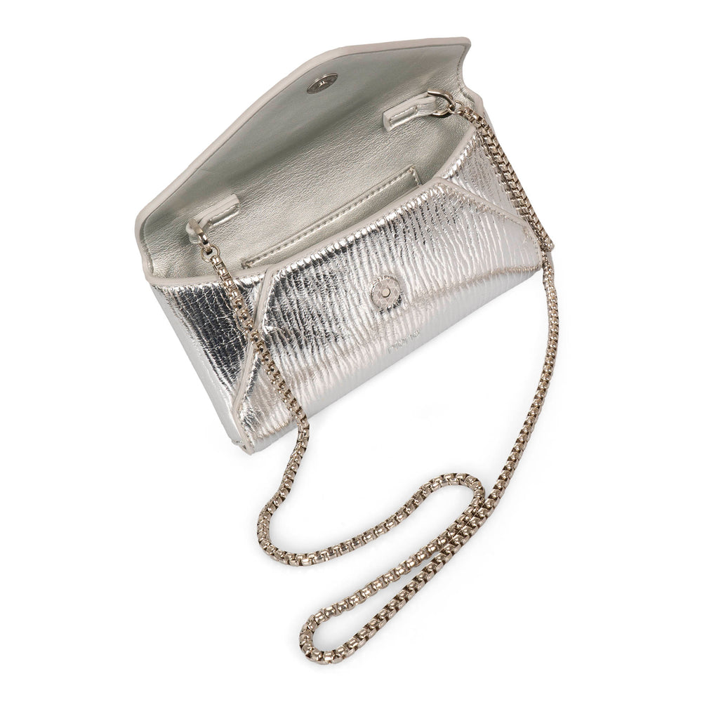 Over head view of metallic silver glossy vegan crossbody bag called Evening in an envelopy style designed by Riona, showcasing its chain strap, matching silver colour interior, an rfid pocket, and snap button closure.